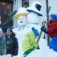 Die Kids bauen auf dem autofreien Platz Schneemänner während die Eltern bummeln und shoppen